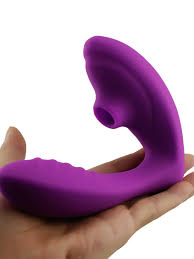 Purple silicone object held in a hand against a white background